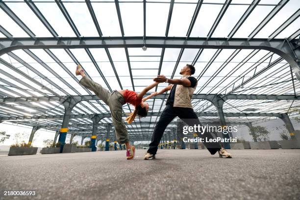 two young people dancing outdoors - street ballet stock pictures, royalty-free photos & images