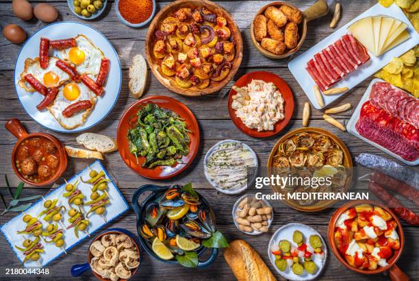 assorted tapas from spain food, typical spanish recipes, and pintxos on a rustic wood - tapas stock pictures, royalty-free photos & images