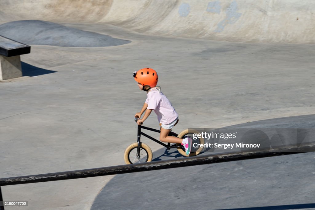 Child Riding Balance Bike in Skatepark