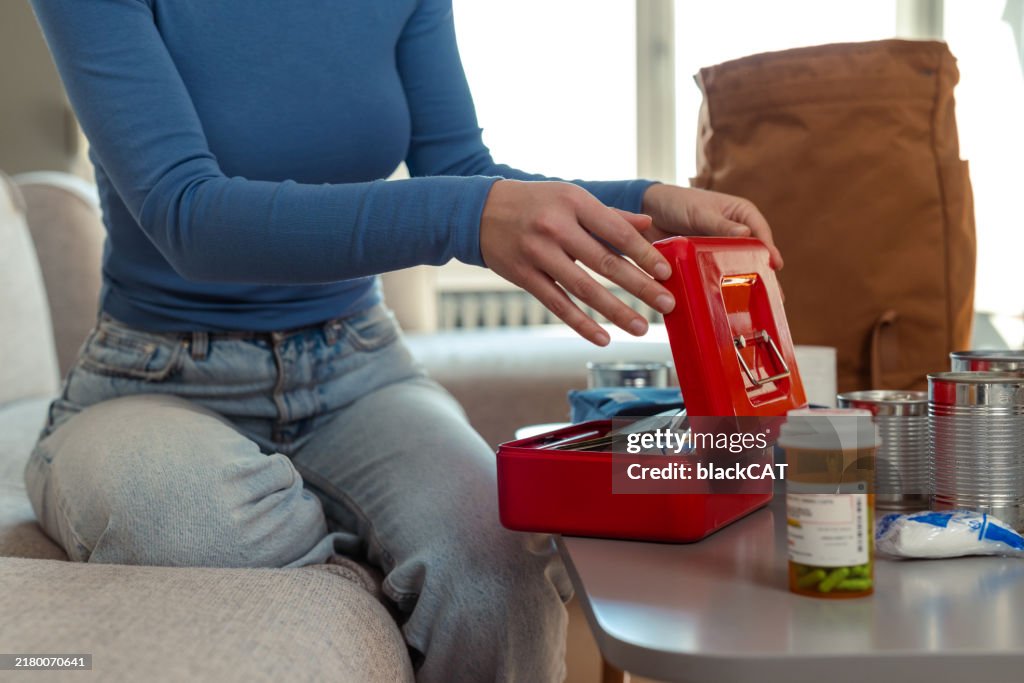 Person organizing emergency supplies for doomsday preparedness