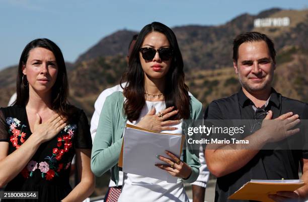 New U.S. Citizens recite the pledge of allegiance during a special naturalization ceremony on the Hollywood Sign Terrace at historic Griffith...