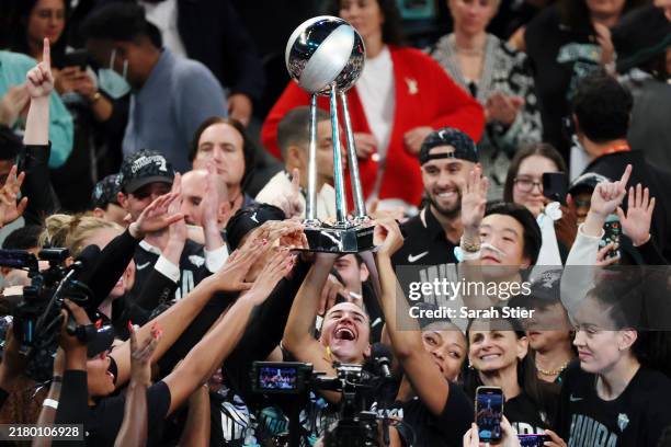 New York Liberty players hoist the WNBA Championship Trophy after defeating the Minnesota Lynx to win Game Five of the WNBA Finals at Barclays Center...