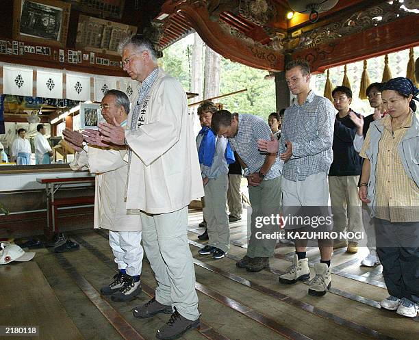 Hartwig Gauder , former German Olympic champion, and his supporters clap hands in prayer for a safe mountain climb to Mt. Fuji at Fuji Sengen Shrine...
