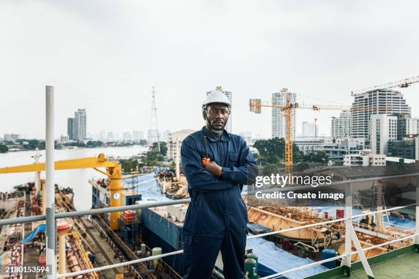 portrait engineer crew working on the ship's deck at shipyard. - trockendock stock-fotos und bilder