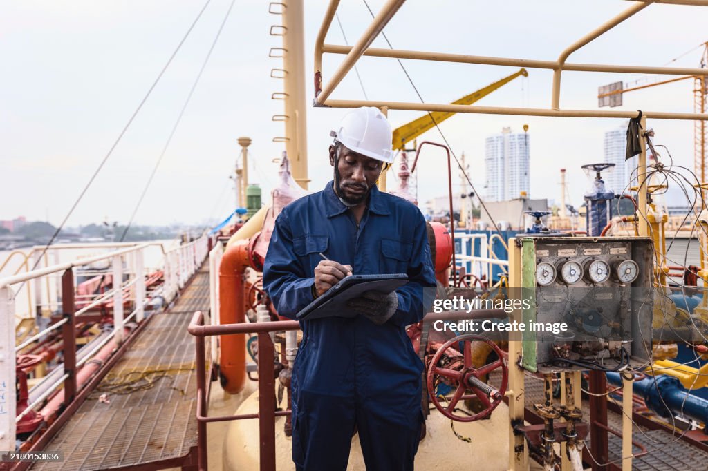 Engineer crew working on oil ship tanker desk for Business logistics import export shipping or freight transportation.