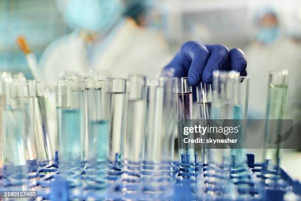 close up of taking test tube in laboratory. - test tube stock pictures, royalty-free photos & images