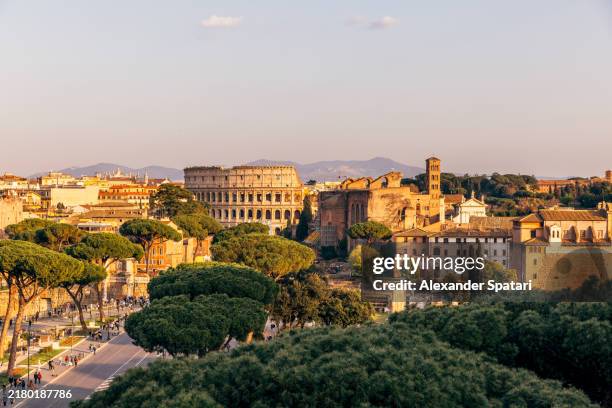 rome cityscape with coliseum and roman forum on a sunny day, aerial view, italy - romano imagens e fotografias de stock