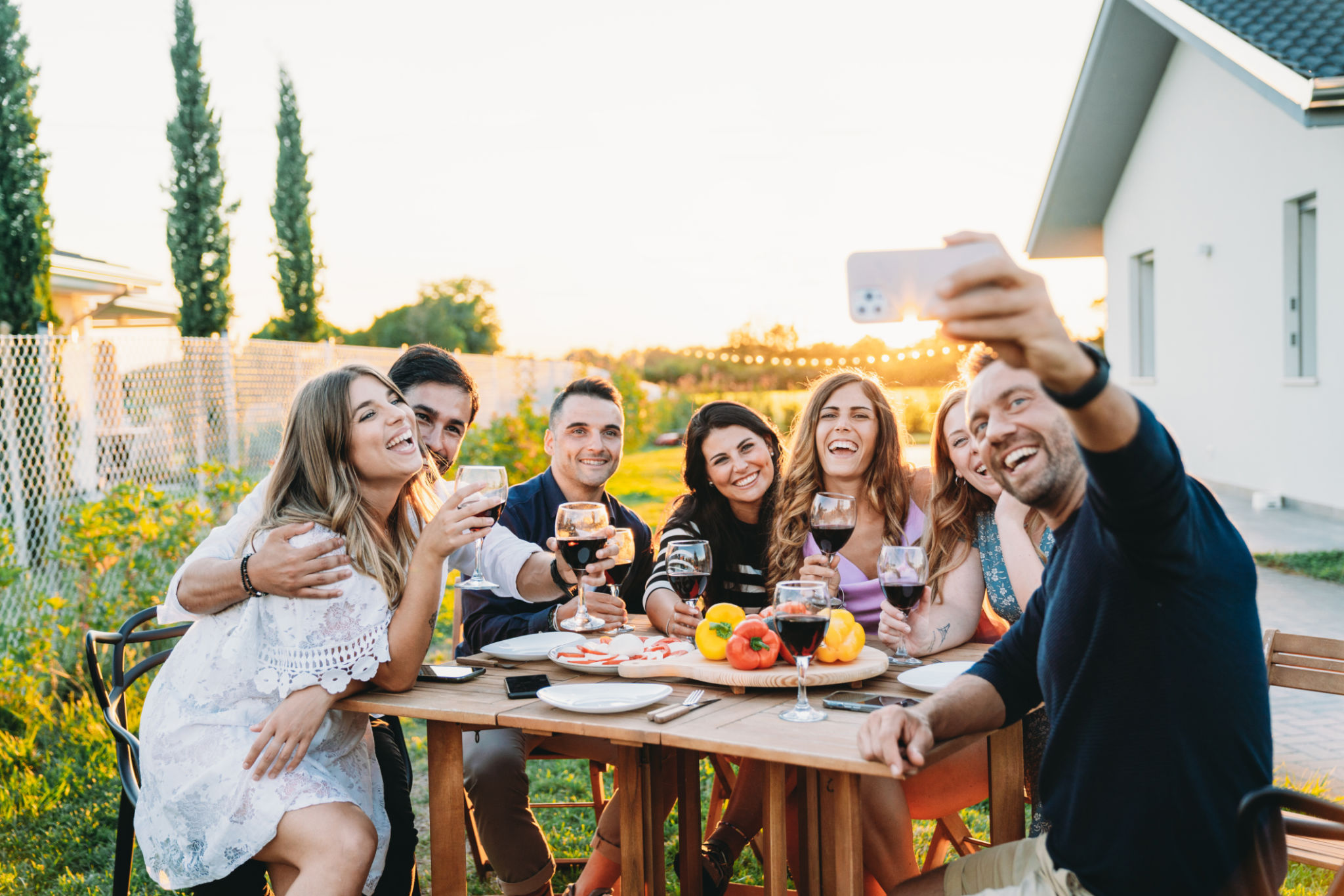 Friends are taking a selfie together during a dinner party Friends are taking a selfie together during a dinner party