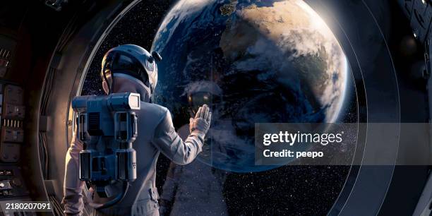 astronaut aboard spacecraft looking at earth - helmet stock pictures, royalty-free photos & images