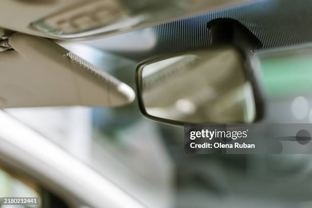car's rearview mirror, visor and windshield. - soft focus stock pictures, royalty-free photos & images