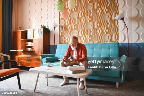 senior man resting in vintage home. - estilo moderno de meados do século imagens e fotografias de stock