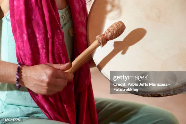 woman playing hand drum, close-up on drumstick and drum - spiritual hippie women stock pictures, royalty-free photos & images