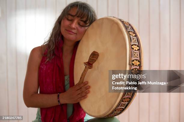 woman hugging traditional drum - spiritual hippie women stock pictures, royalty-free photos & images