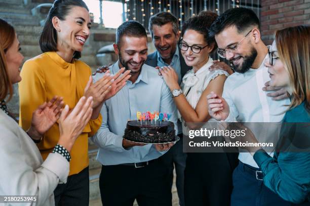 team celebrating a birthday at the office. - wedding anniversary stock pictures, royalty-free photos & images