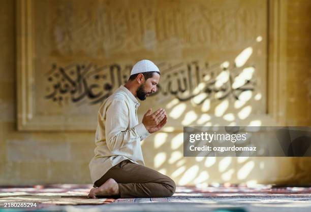 muslim man praying in mosque (namaz) - muslim-god-allah stock pictures, royalty-free photos & images