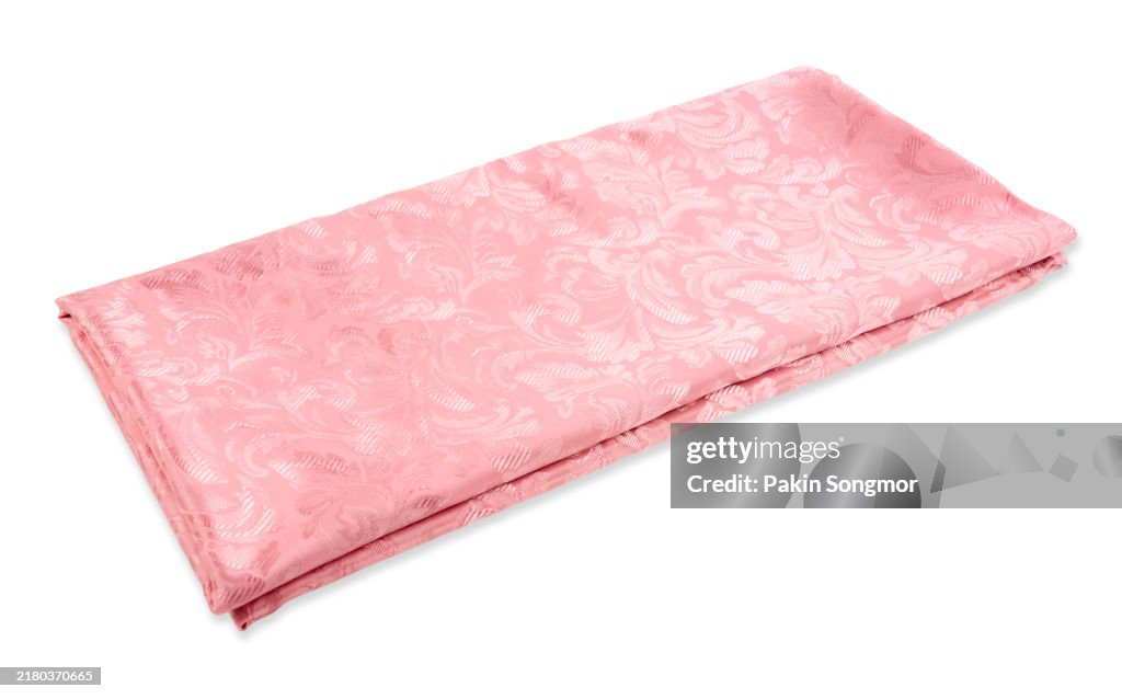 Folded pink satin blanket isolated on white background, Save clipping path.