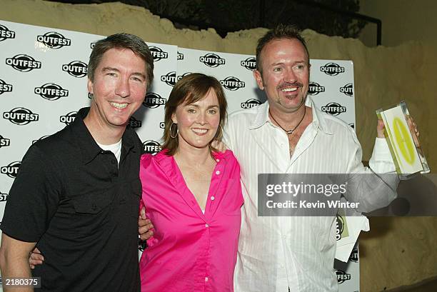 Kirkland Tibbles and actress Laura Innes pose with filmmaker C. Jay Cox pose and his Best First Feature award for the film "Latter Days" during...