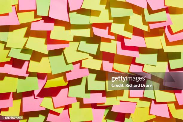 a group of adhesive notes stuck to a wall - sticky stock pictures, royalty-free photos & images
