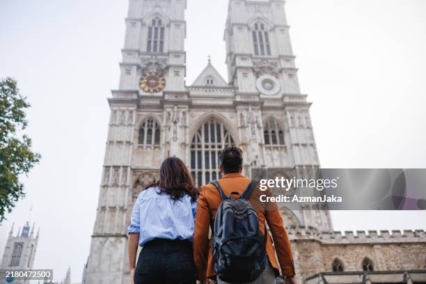 couple exploring westminster abbey in london - cloudy eye stock pictures, royalty-free photos & images