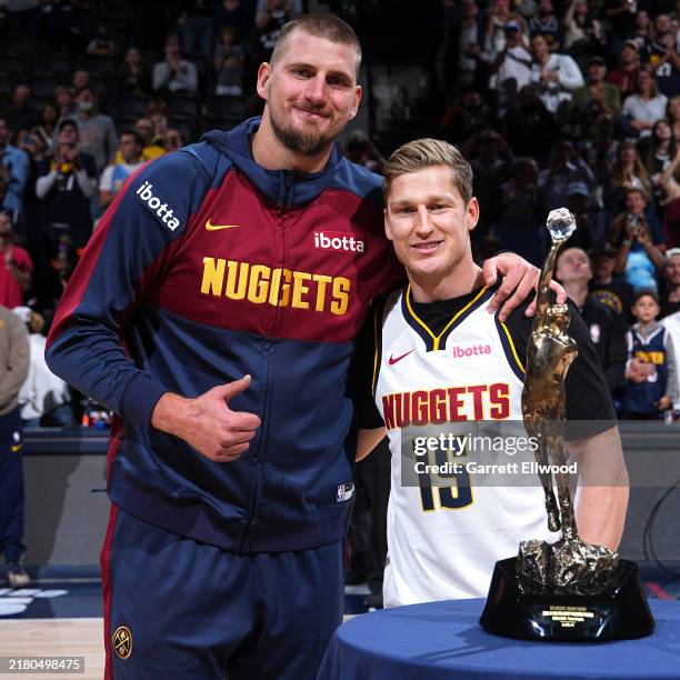 Nathan MacKinnon presents the 2023-24 Kia NBA Most Valuable Player Nikola Jokic of the Denver Nuggets the Michael Jordan Trophy before the game...