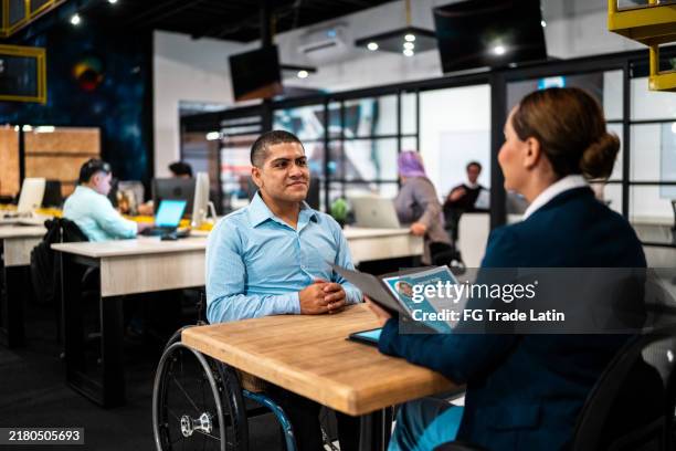 young man in a job interview at the office - recrutamento imagens e fotografias de stock