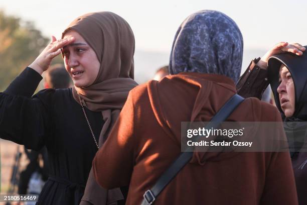 Relatives of employees watch on following an attack on October 23, 2024 in Ankara, Turkey. An attack occurred at the Turkish Aerospace Industries...