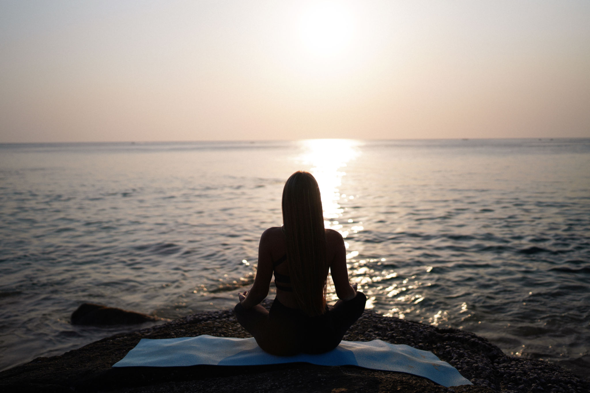 Silhouette of young woman doing yoga at sunset Silhouette of young woman doing yoga at sunset