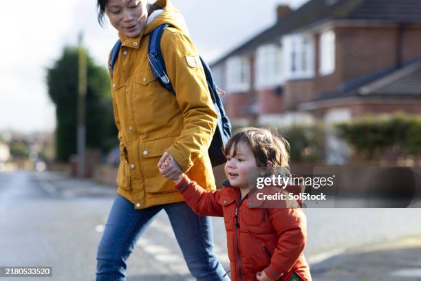 mother and son walking hand in hand - single mother stock pictures, royalty-free photos & images