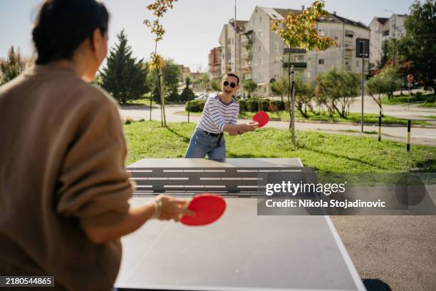 female players with a ping pong ball - table tennis net stock pictures, royalty-free photos & images