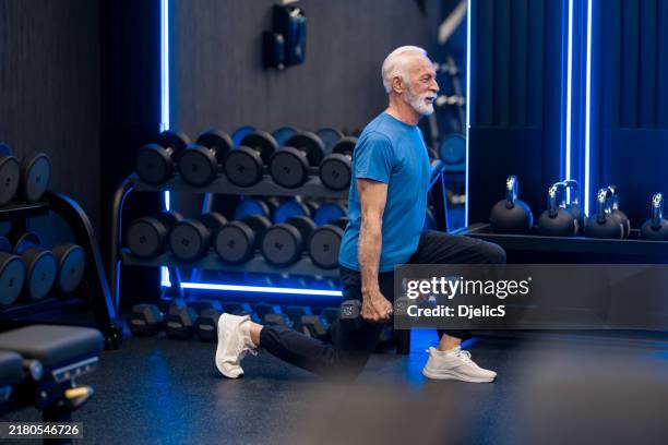 senior man exercising in the gym. - tyngdlyftning bildbanksfoton och bilder