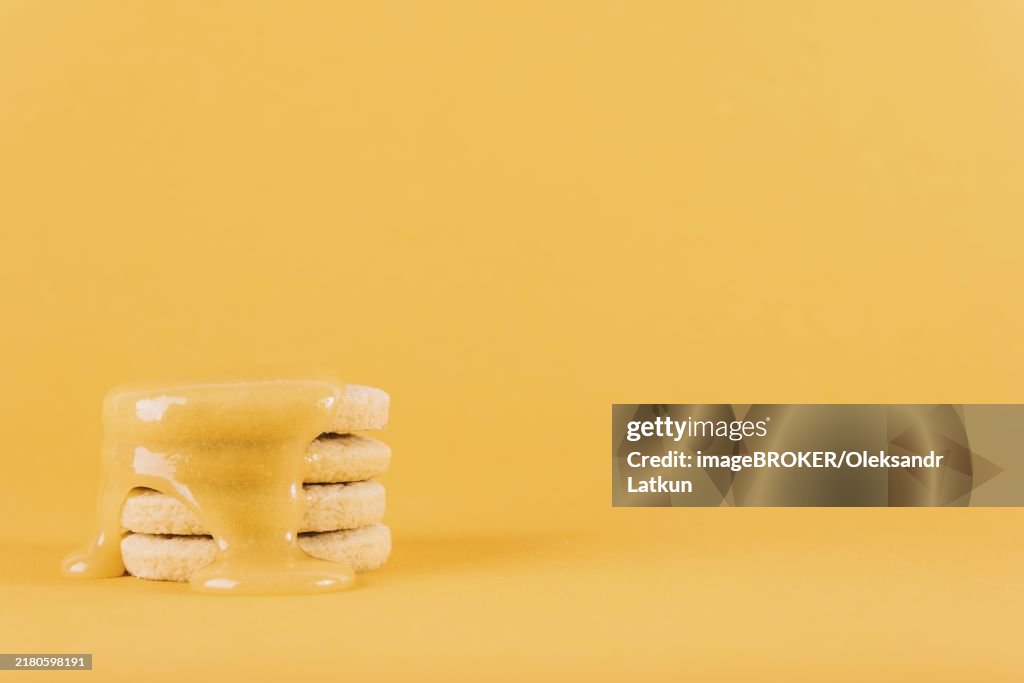 Stacked cookies with lemon curd yellow background
