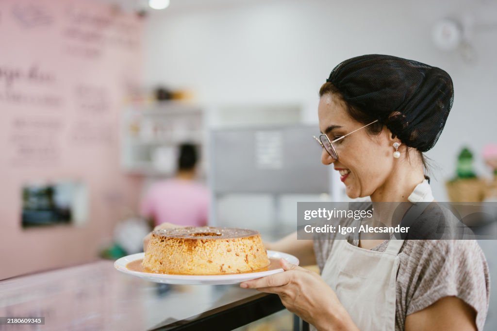 Waitress holding bowl of milk pudding