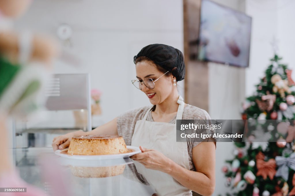 Waitress holding bowl of milk pudding