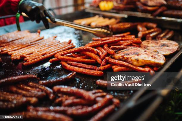 food stall with fresh meat at christmas market. - salsicha imagens e fotografias de stock