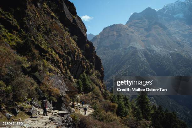View of trekkers along the mountain pathway that leads out of Namche Bazaar on October 09, 2024 in Deboche, Nepal. Trekking in Nepal offers...