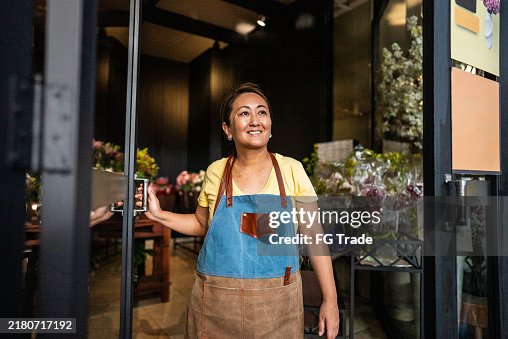Mature saleswoman contemplating at a garden center Mature saleswoman contemplating at a garden center
