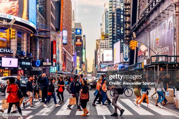 people crossing the street near times square, manhattan, new york city, usa - theatre district stock pictures, royalty-free photos & images