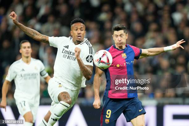 Eder Militao centre-back of Real Madrid and Brazil and Robert Lewandowski centre-forward of Barcelona and Poland compete for the ball during the La...