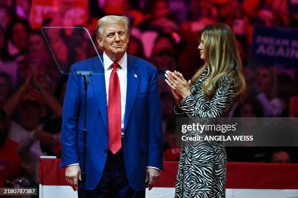 Former US First Lady Melania Trump applauds her husband former US President and Republican presidential candidate Donald Trump after he spoke at a...