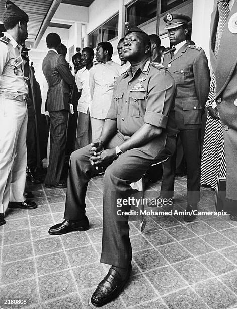 Ugandan President Idi Amin resting on a shooting stick while attending the Organization for African Unity summit in Libreville, circa 1971. He told...