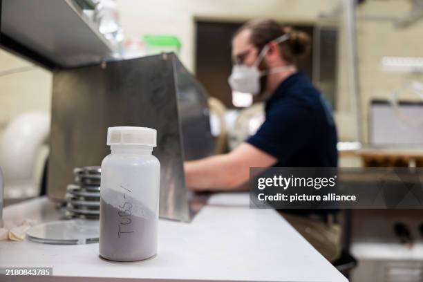 October 2024, Lower Saxony, Brunswick: A laboratory bottle with synthetic lunar regolith stands in the "Comet Physics Laboratory" at the Institute of...