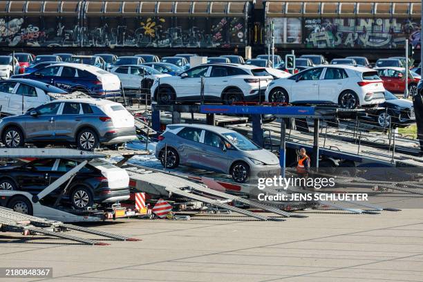 Employees load and unload Volkswagen cars at the plant's premises in Zwickau, eastern Germany on October 28 after auto giant Volkswagen announced...