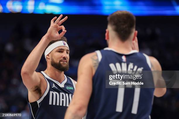 Klay Thompson of the Dallas Mavericks congratulates Luka Doncic on his three-point basket against the San Antonio Spurs during the third quarter at...