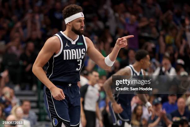 Klay Thompson of the Dallas Mavericks reacts after scoring against the San Antonio Spurs during the third quarter at American Airlines Center on...