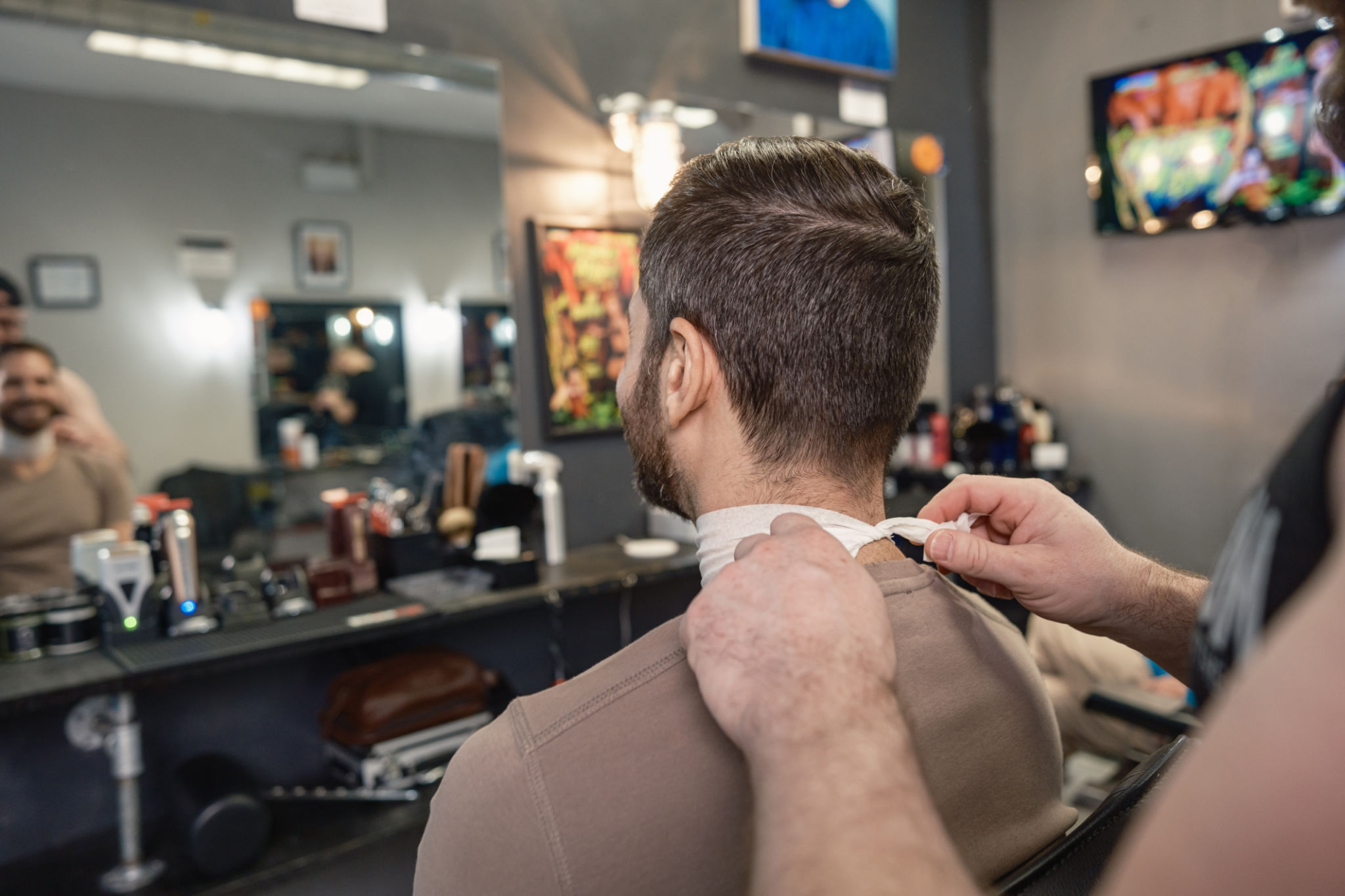Gay man getting a trim at the barber shop Gay man getting a trim at the barber shop