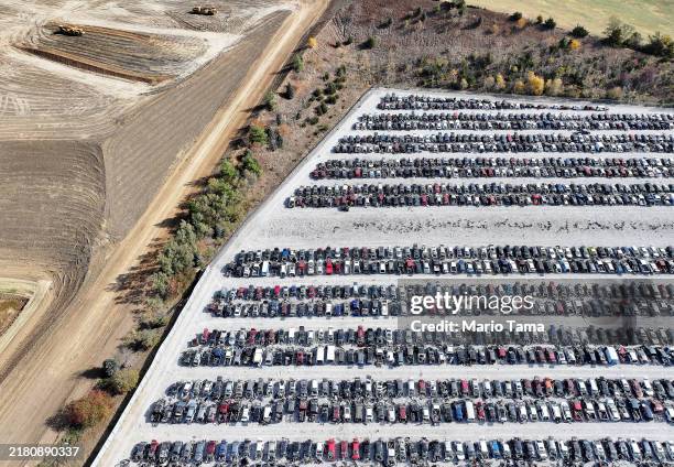 An aerial view of former farmland being regraded for development next to an automobile junkyard on October 24, 2024 near Omaha, Nebraska. Nebraska...