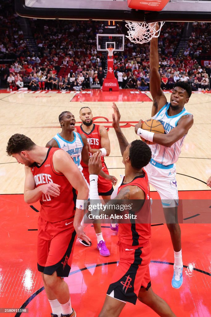 Hornets Rockets 2002 Brandon Miller of the Charlotte Hornets slam dunks the ball over ...