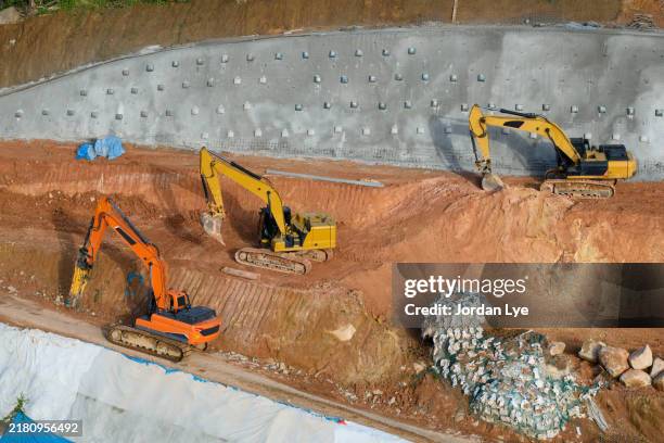 aerial view of diggers at construction site - construction sand stock pictures, royalty-free photos & images