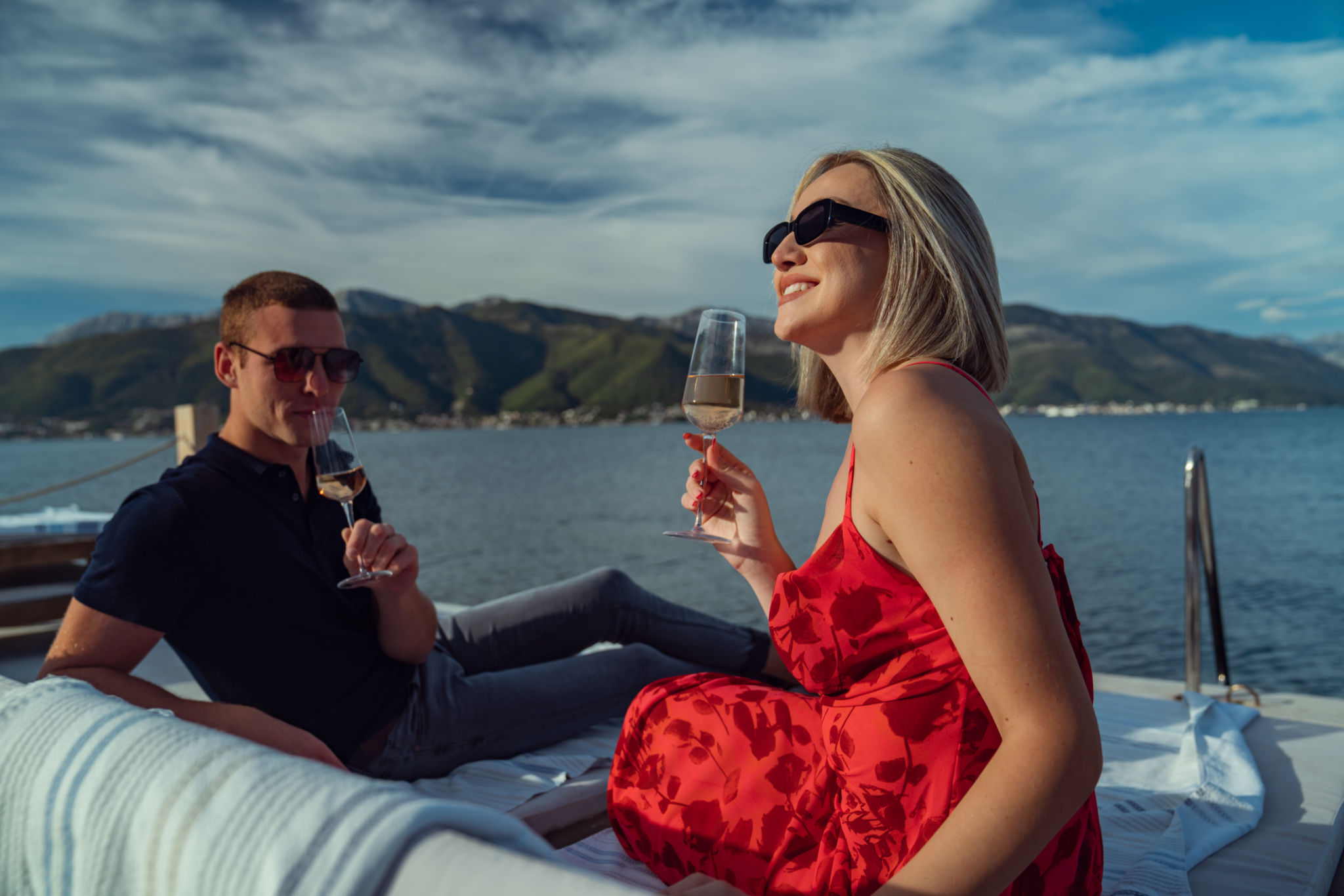 Tranquil afternoon by the sea: couple enjoying on the dock of an upscale coastal retreat Tranquil afternoon by the sea: couple enjoying on the dock of an upscale coastal retreat