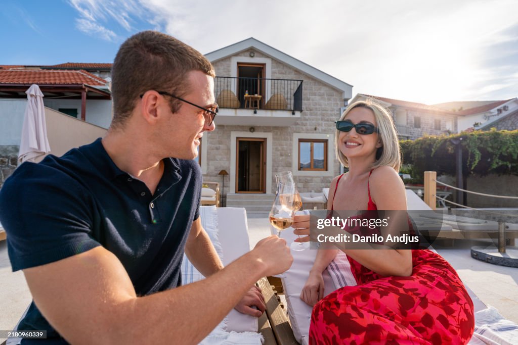 Relaxed moments: couple enjoying a sunny afternoon together and having Champagne